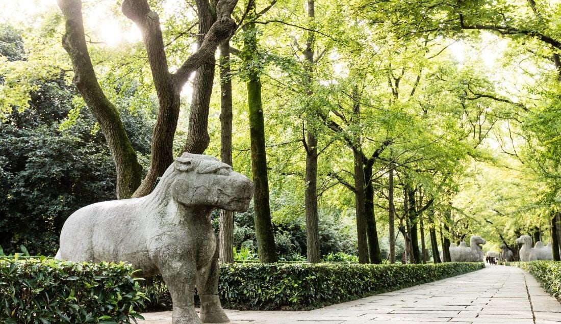 Walk the Sacred Way, a path of stone statues leading to Ming tombs.