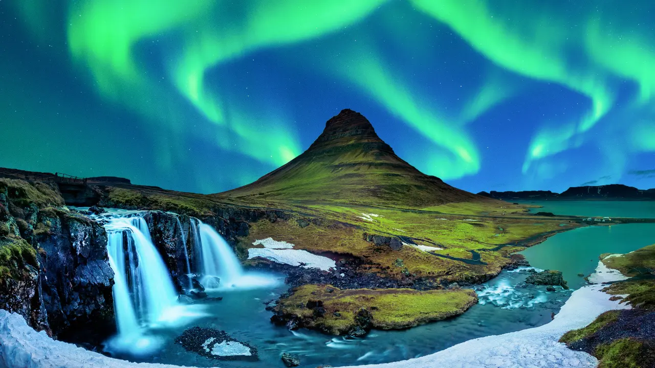 Northern lights over a mountain landscape in Iceland